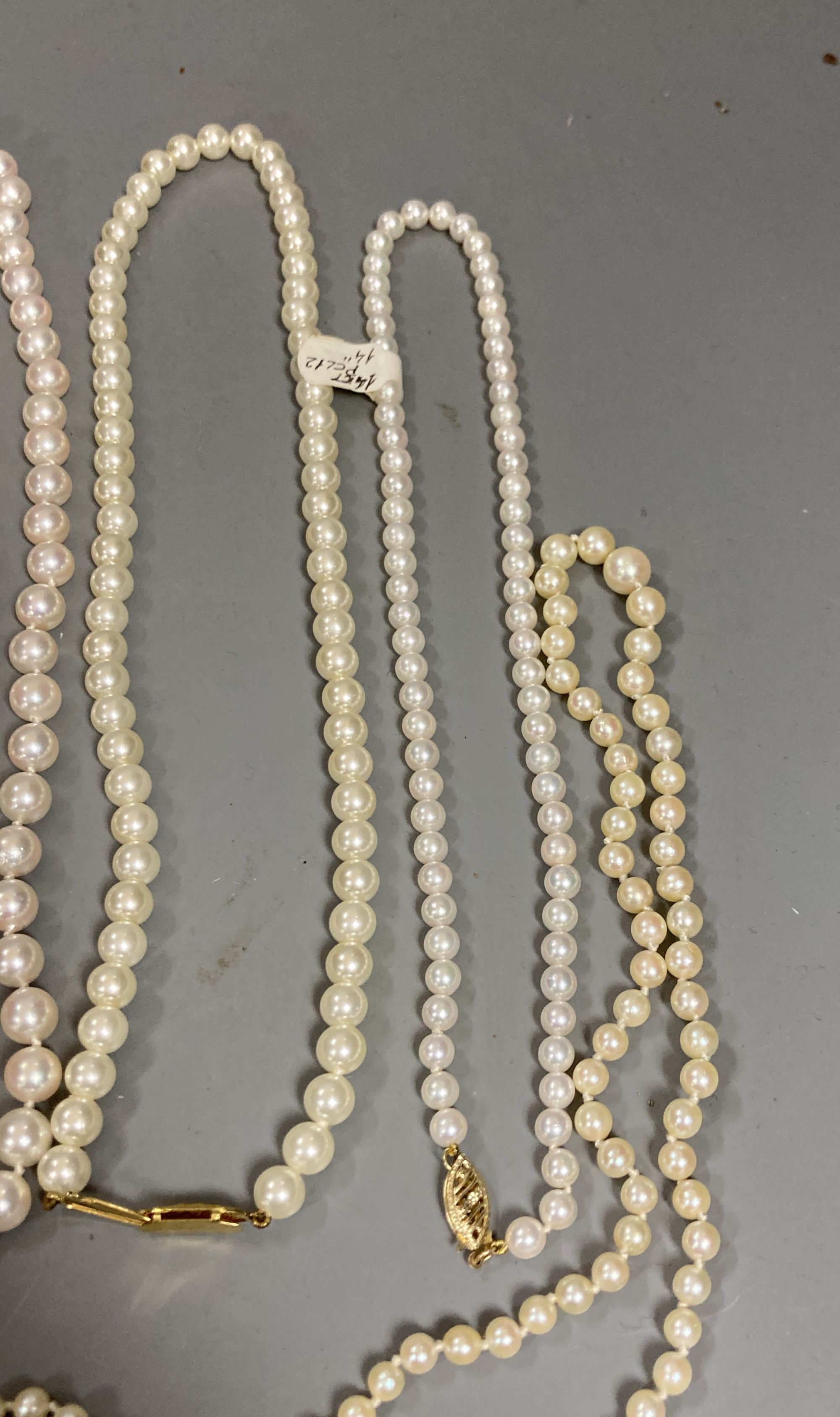 Four assorted modern single strand cultured pearl necklaces, longest 83cm, one other 9ct and cultured pearl necklace(a.f.) and two simulated pearl necklaces.